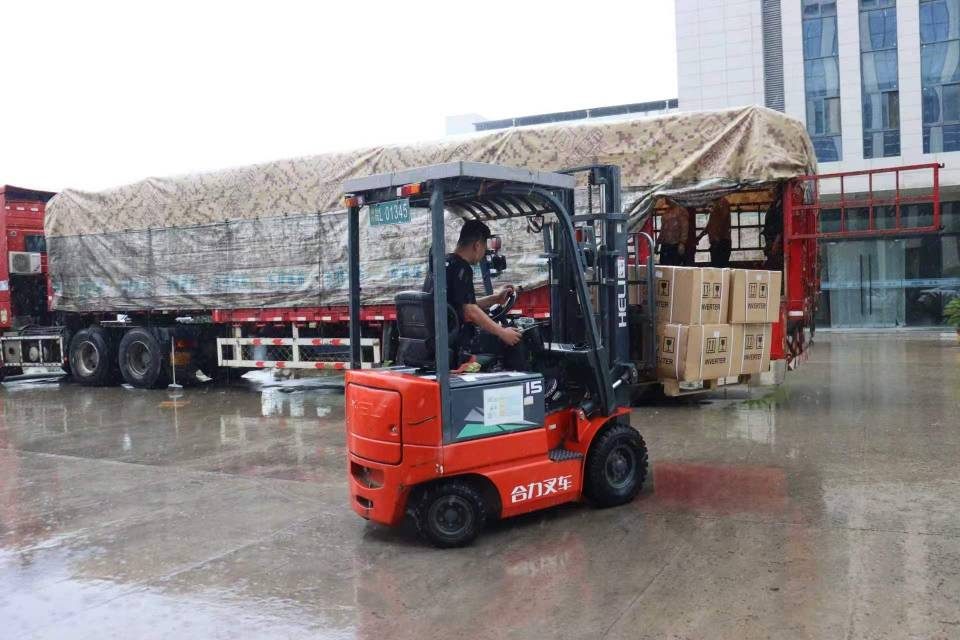Forklift moving palletised goods for container loading