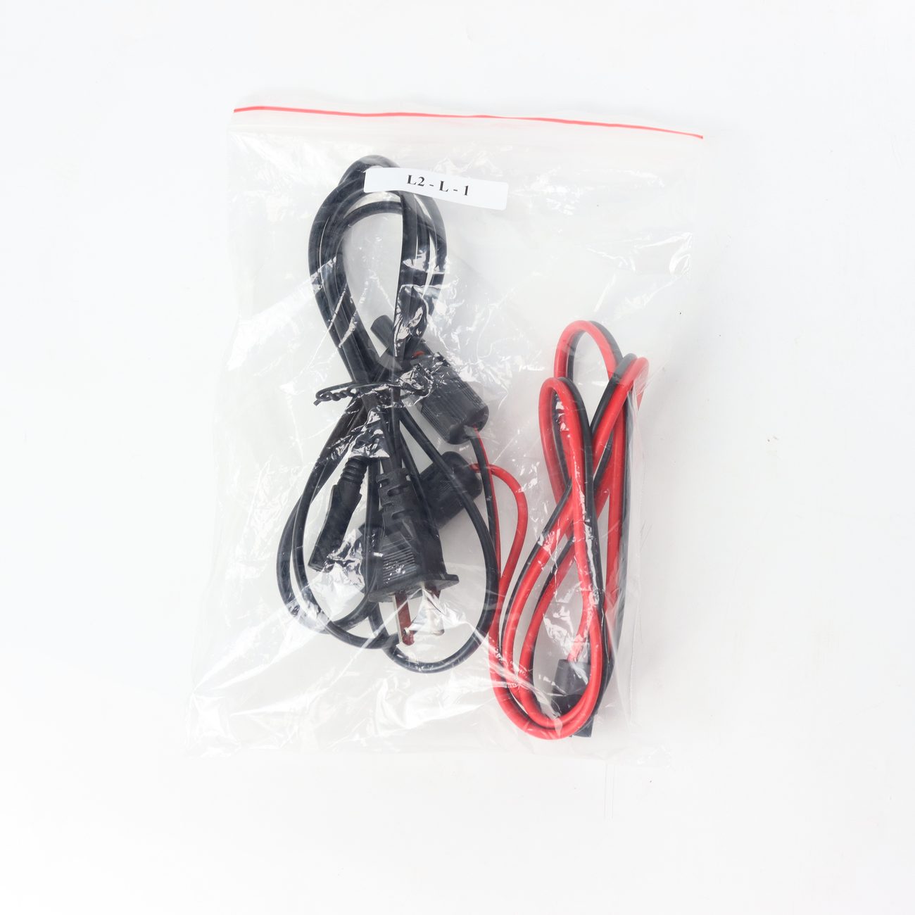 Accessory set supplied with a portable energy storage unit including AC lead and battery cable